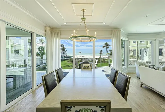 a view of a dining room with furniture wooden floor and chandelier