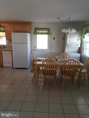 a kitchen with a stove a refrigerator and a sink