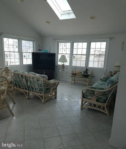 a view of a dining room and livingroom with furniture window and outside view