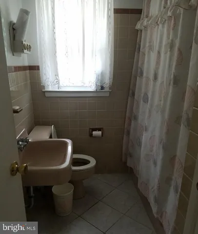 a living room with furniture and a lamp