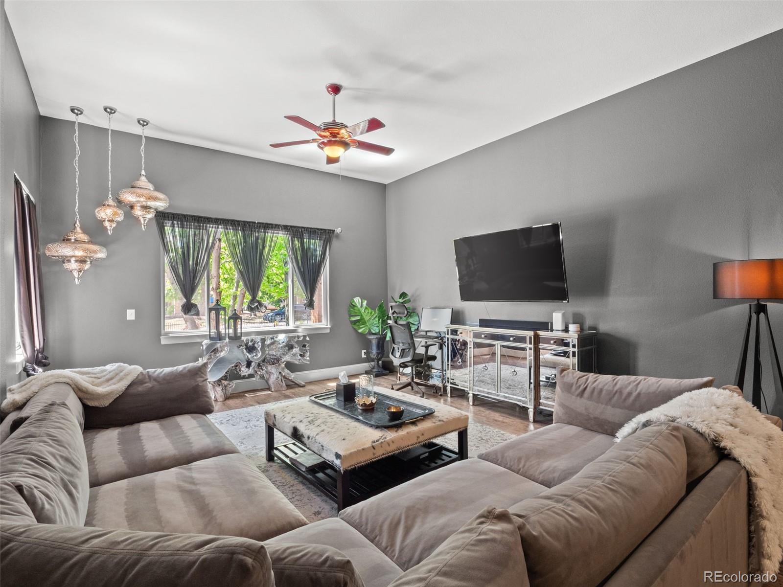 6595 West 46th Place Wheat Ridge, CO 80033 - Photo 13 of 48 a living room with furniture and a flat screen tv
