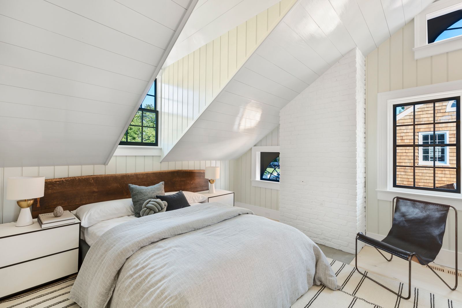 43 Howard Street Sag Harbor, NY 11963 - Photo 21 of 31 a bedroom with a bed and chair