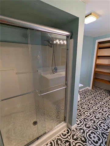 a bathroom with a glass door shower