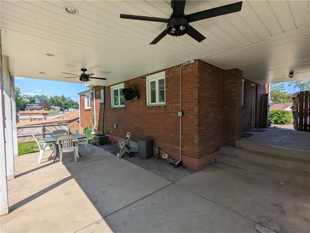 a view of a patio with table and chairs with wooden floor
