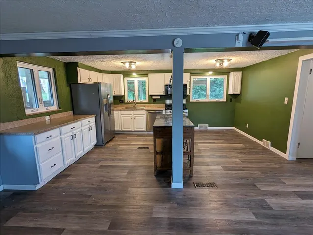 a kitchen with sink and wooden floor