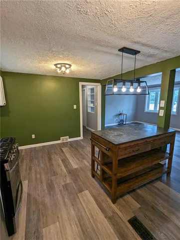 a room with wooden floors and lots of wooden cabinets