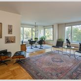 a living room with furniture a rug and a large window