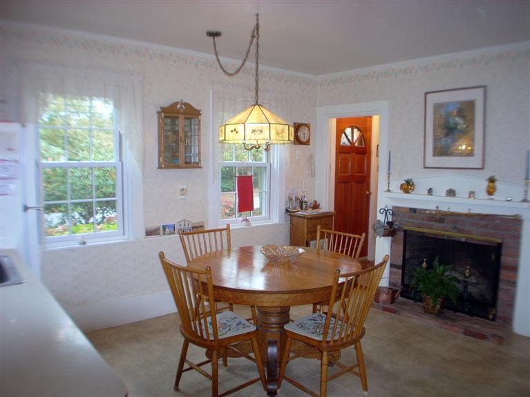 265 Chatham Road Harwich, MA 02645 - Photo 7 of 35 a dining room with furniture a fireplace and a chandelier