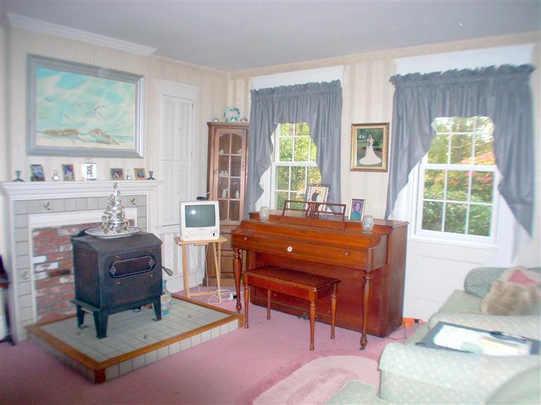 265 Chatham Road Harwich, MA 02645 - Photo 9 of 35 a living room with furniture a fireplace and large windows