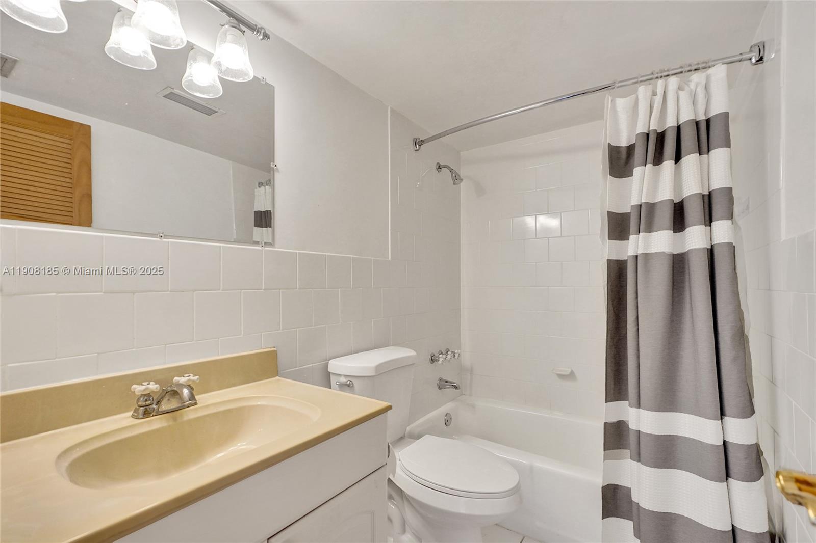 8335 Southwest 72nd Avenue, Unit 205D Miami, FL 33143 - Photo 11 of 19 a bathroom with a sink a toilet and shower