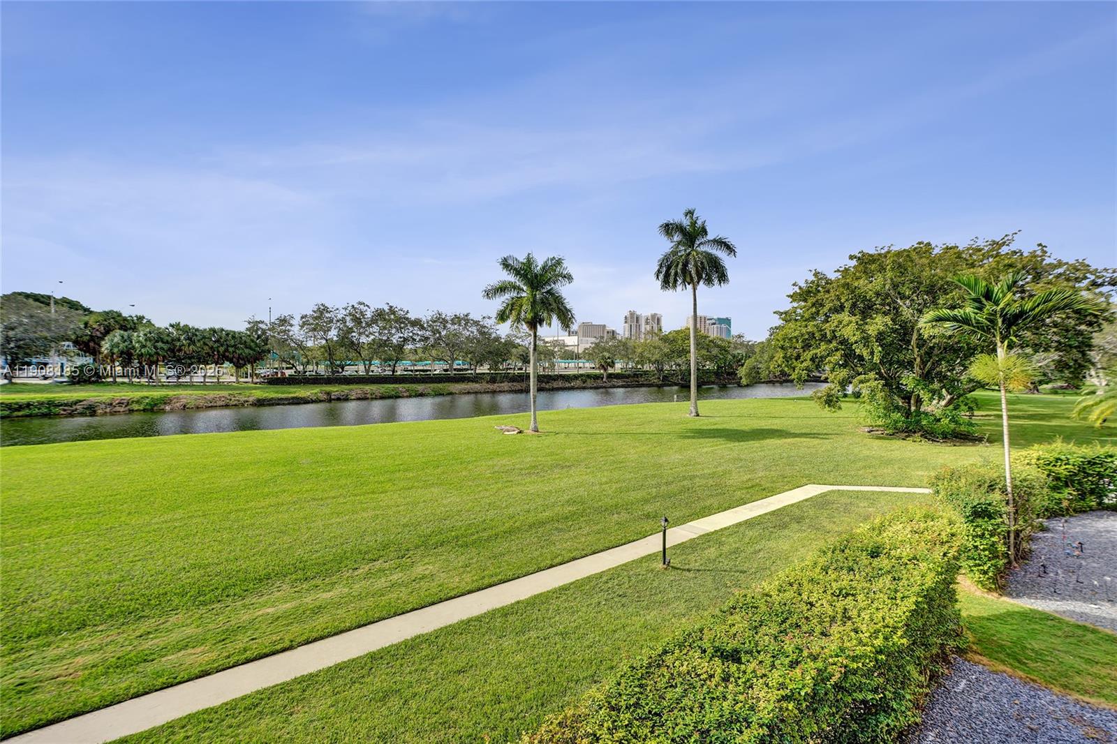 8335 Southwest 72nd Avenue, Unit 205D Miami, FL 33143 - Photo 14 of 19 a view of a golf course with a lake