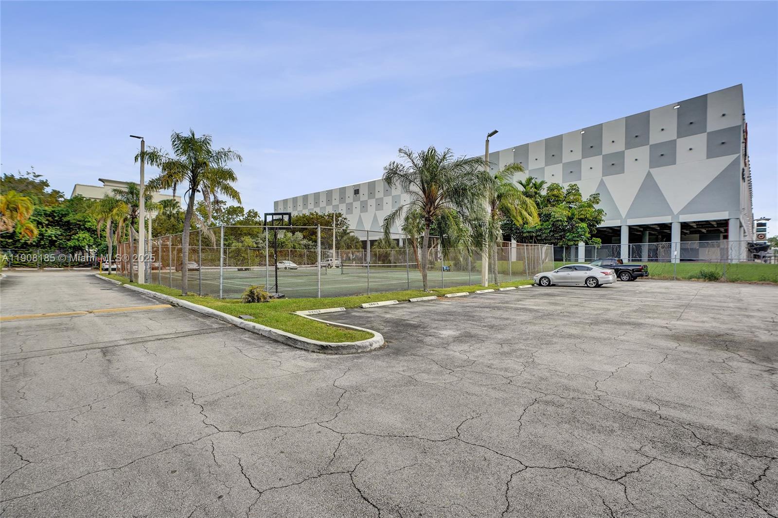 8335 Southwest 72nd Avenue, Unit 205D Miami, FL 33143 - Photo 16 of 19 a view of a building with a palm tree