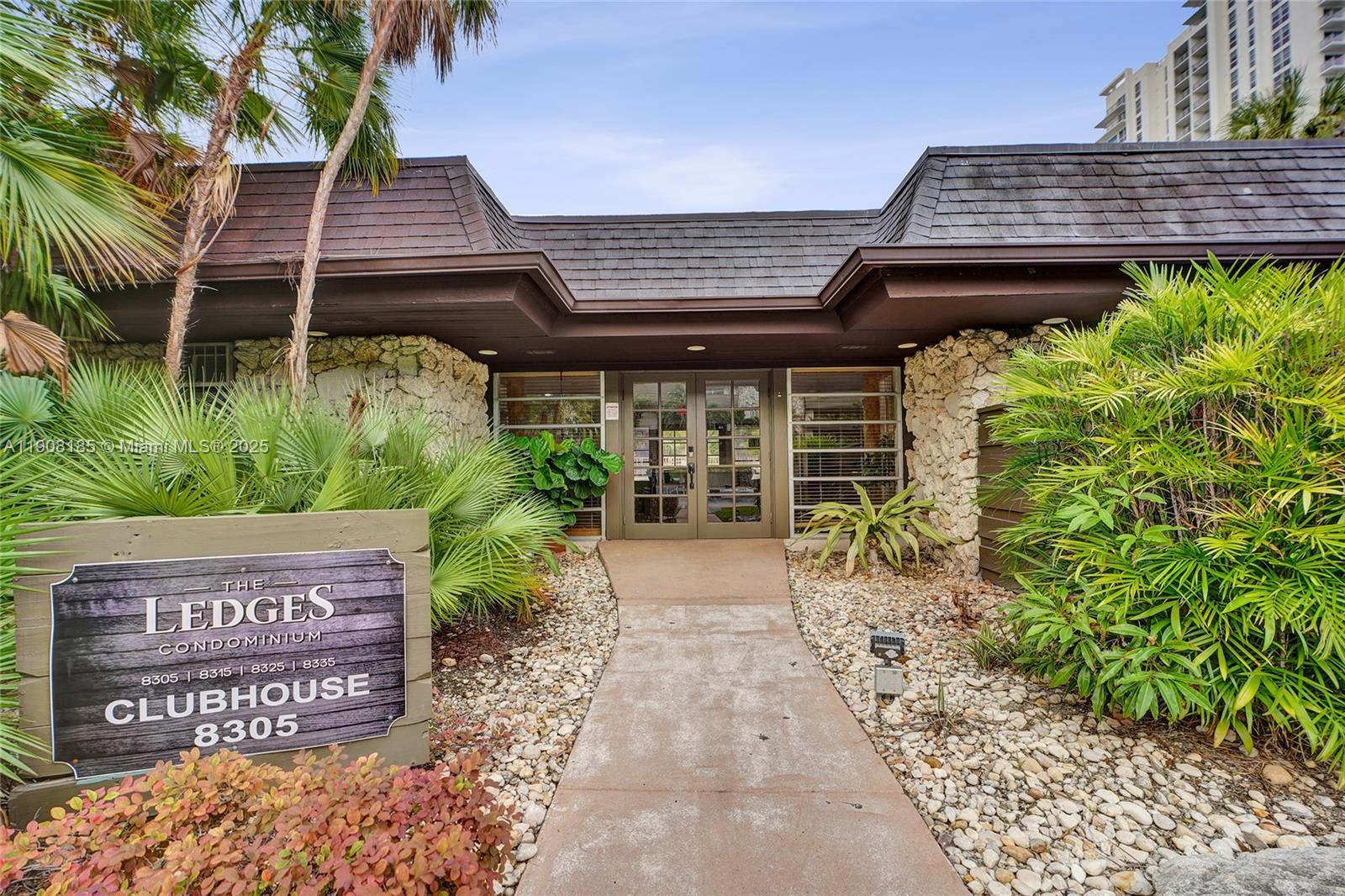 8335 Southwest 72nd Avenue, Unit 205D Miami, FL 33143 - Photo 17 of 19 a view of a wooden door with a bench in front of house