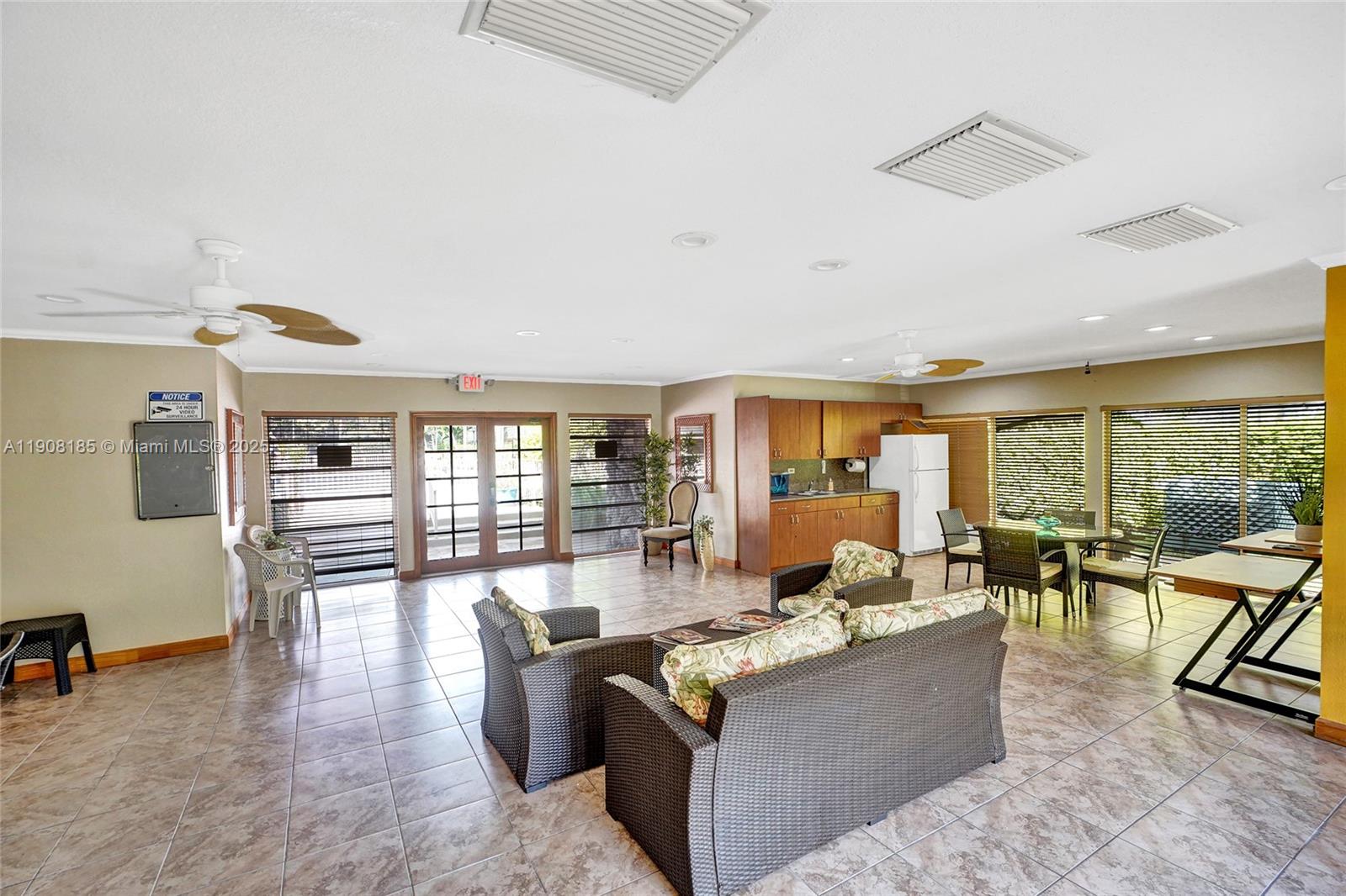 8335 Southwest 72nd Avenue, Unit 205D Miami, FL 33143 - Photo 18 of 19 a living room with fireplace furniture and floor to ceiling window