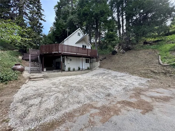 a view of a house with a yard and sitting area