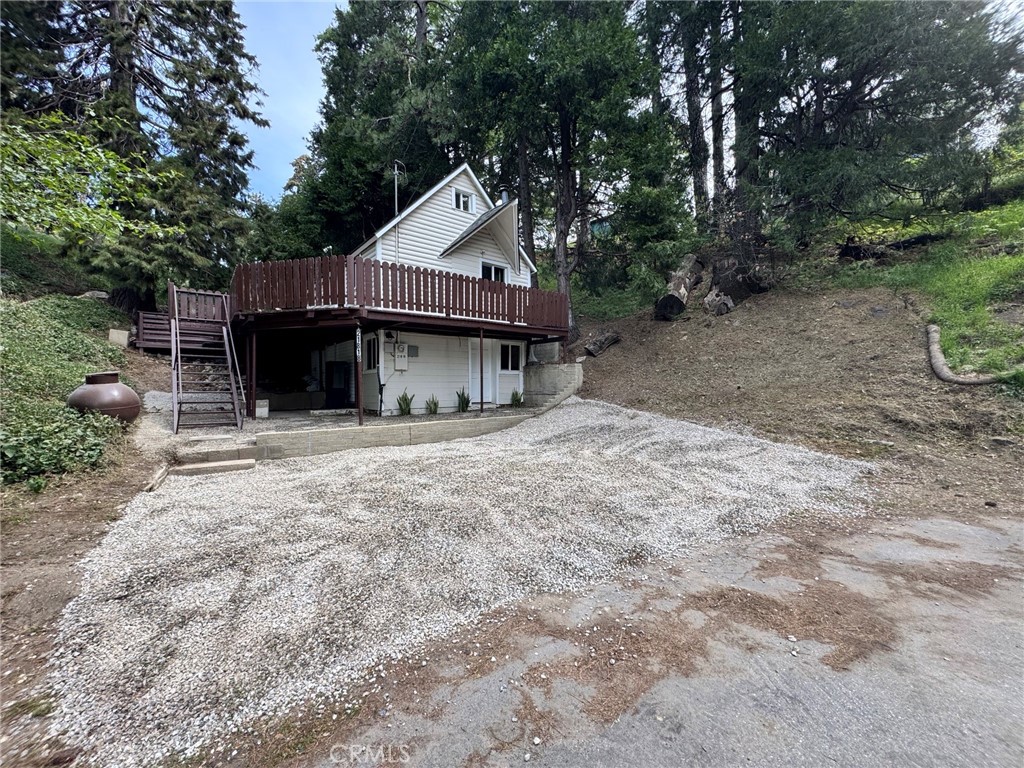a view of a house with a yard and sitting area