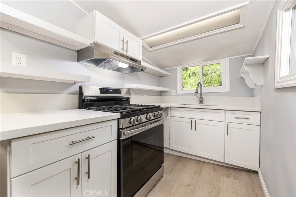 21818 Vista Road Cedarpines Park, CA 92322 - Photo 11 of 41 a kitchen with stainless steel appliances granite countertop a sink and a stove