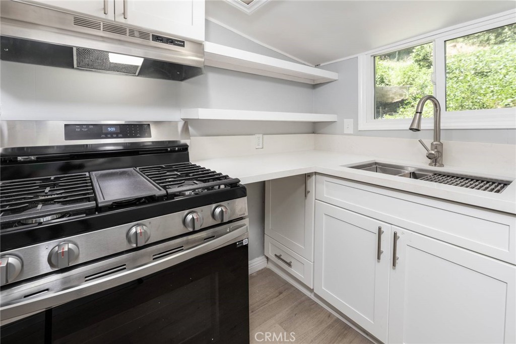 21818 Vista Road Cedarpines Park, CA 92322 - Photo 12 of 41 a kitchen with a stove cabinets and window
