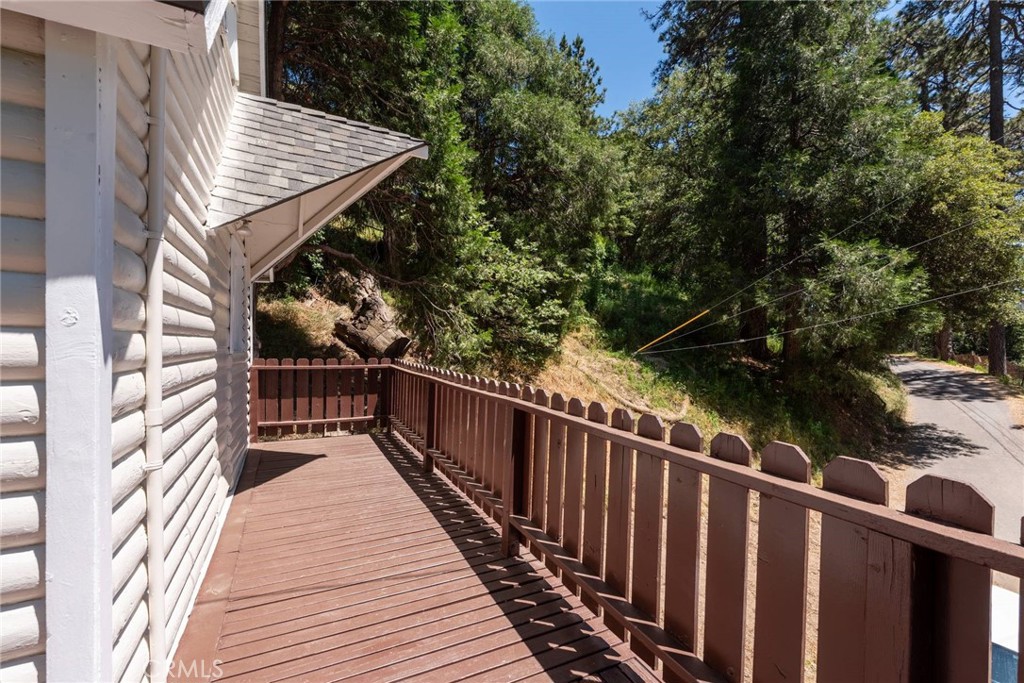 21818 Vista Road Cedarpines Park, CA 92322 - Photo 23 of 41 a balcony with wooden floor and wooden fence