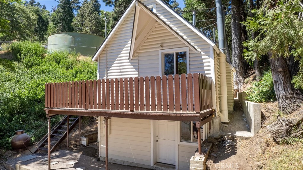 21818 Vista Road Cedarpines Park, CA 92322 - Photo 39 of 41 a view of a wooden house with a large window and furniture