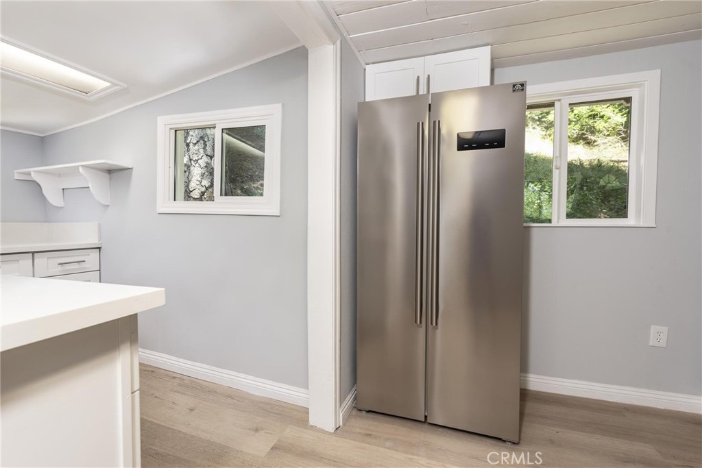 21818 Vista Road Cedarpines Park, CA 92322 - Photo 10 of 41 a view of a kitchen with wooden floor and a refrigerator