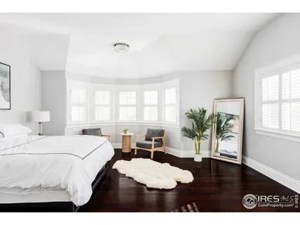 a living room with a bed furniture and a window