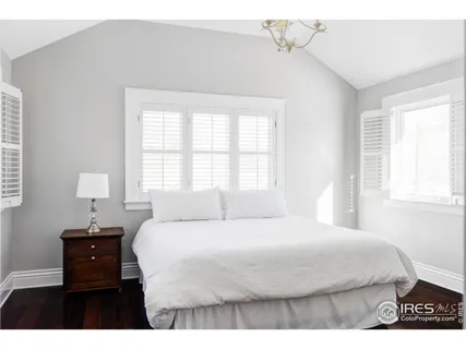 a bedroom with a bed and a night stand