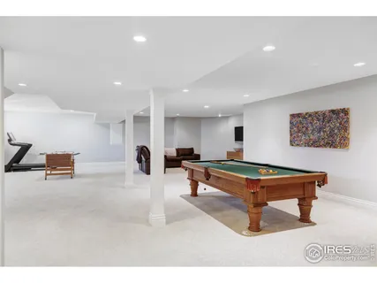 a room with furniture pool table and window