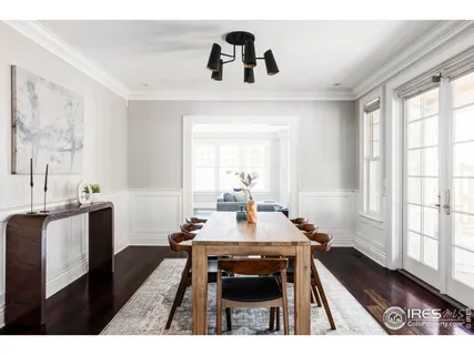 a dining room with a window and chairs