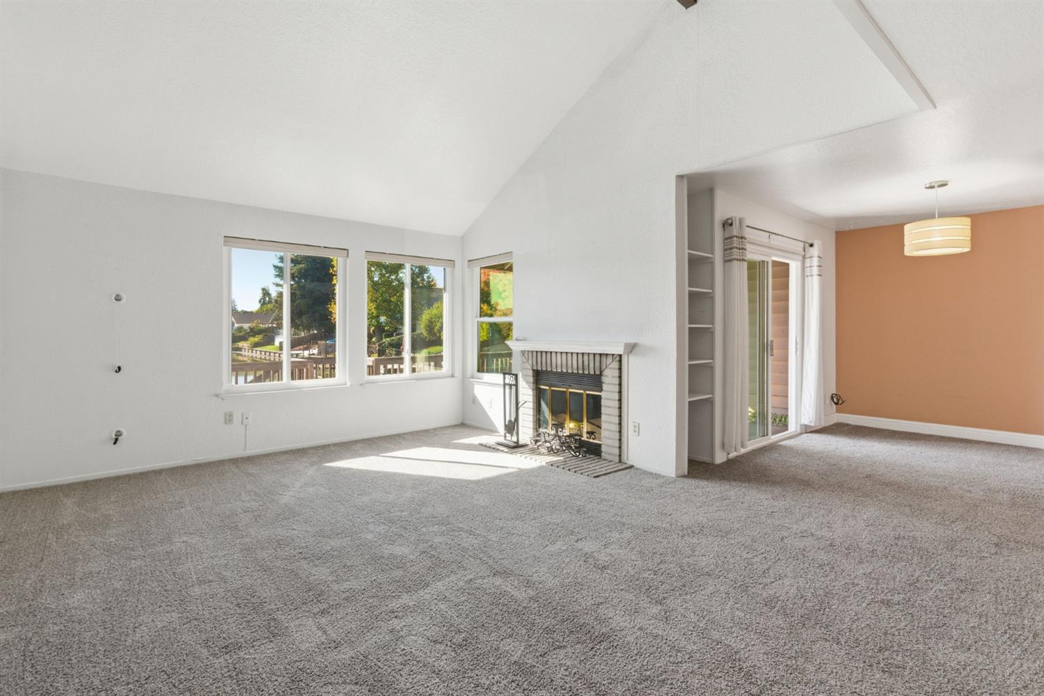7348 Lighthouse Drive Stockton, CA 95219 - Photo 14 of 56 an empty room with windows and fireplace