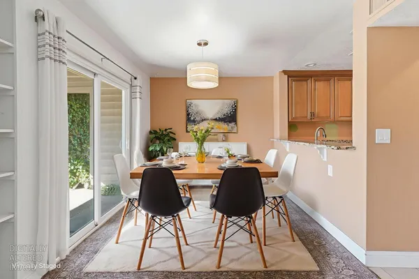 a view of kitchen with stainless steel appliances granite countertop refrigerator stove top oven and cabinets