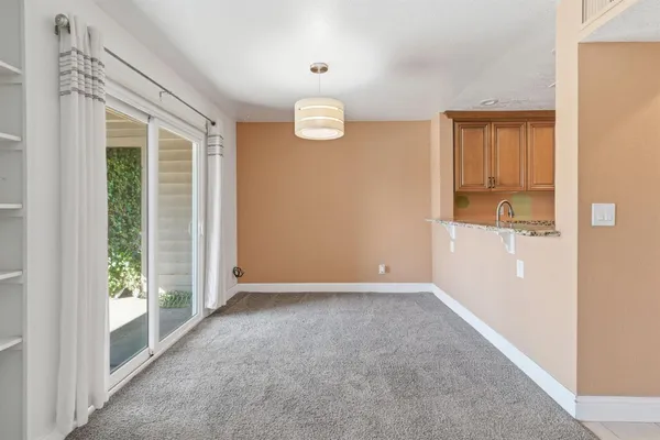 an empty room with windows and view of an empty room