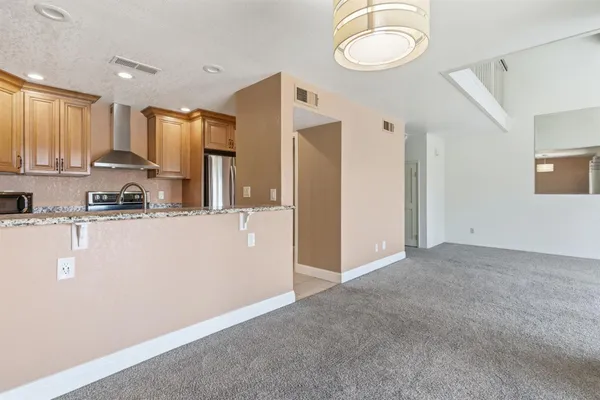 a kitchen with stainless steel appliances granite countertop a stove sink and cabinets