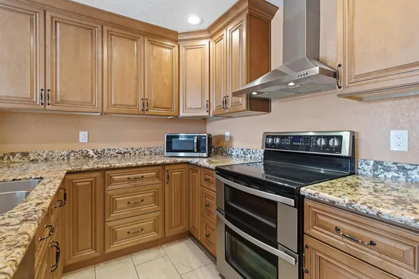 a kitchen with stainless steel appliances granite countertop a stove and a refrigerator