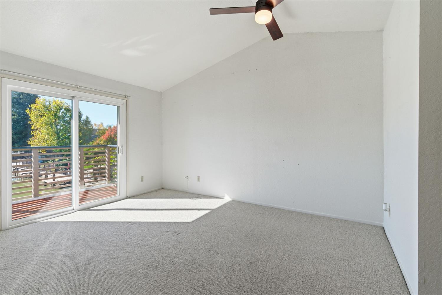 7348 Lighthouse Drive Stockton, CA 95219 - Photo 32 of 56 a view of an empty room with wooden floor and windows