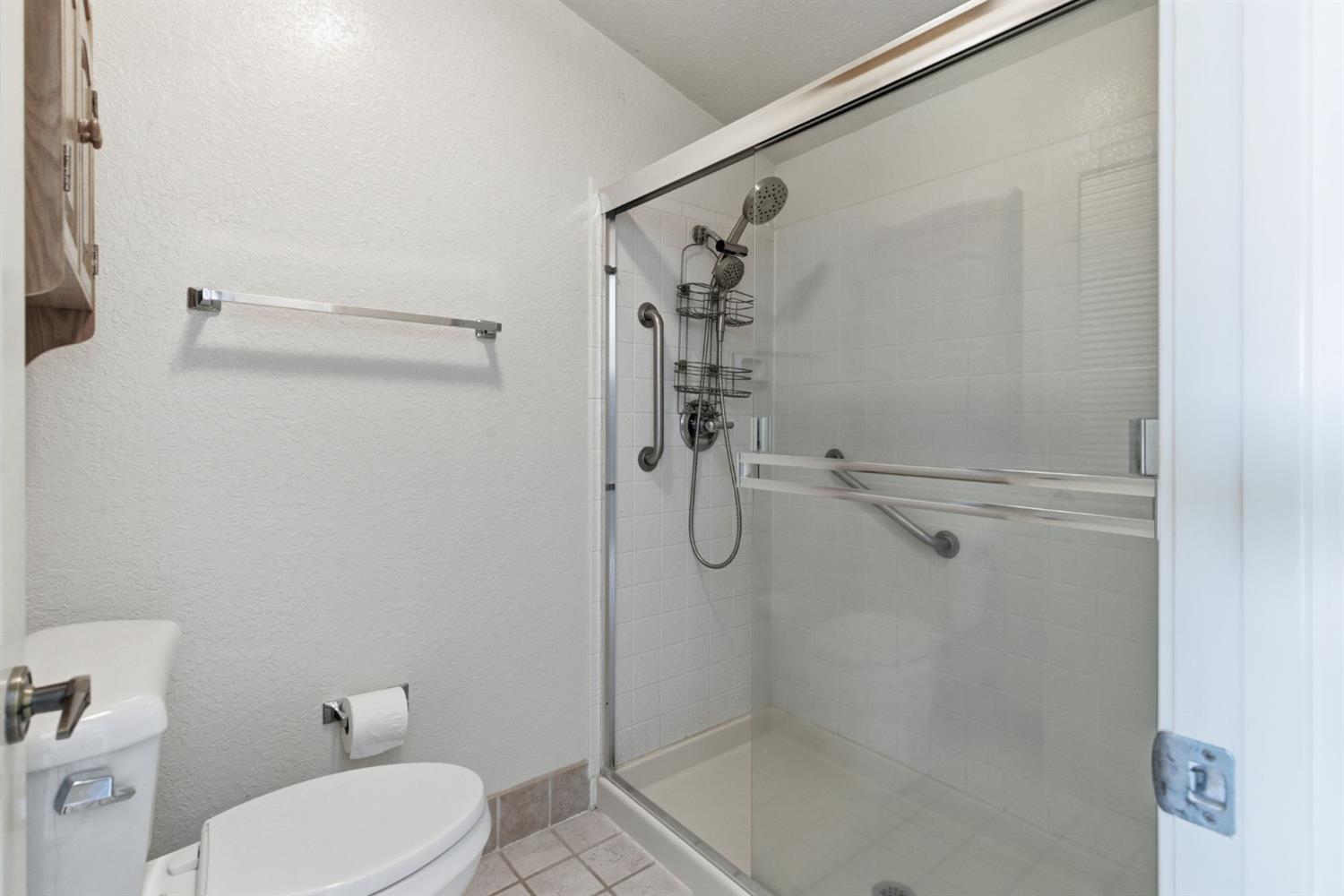 7348 Lighthouse Drive Stockton, CA 95219 - Photo 36 of 56 a bathroom with a shower and toilet