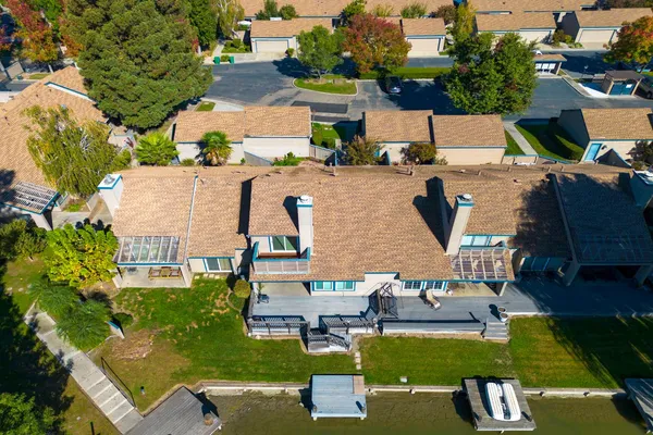 an aerial view of a house with a yard basket ball court and outdoor seating