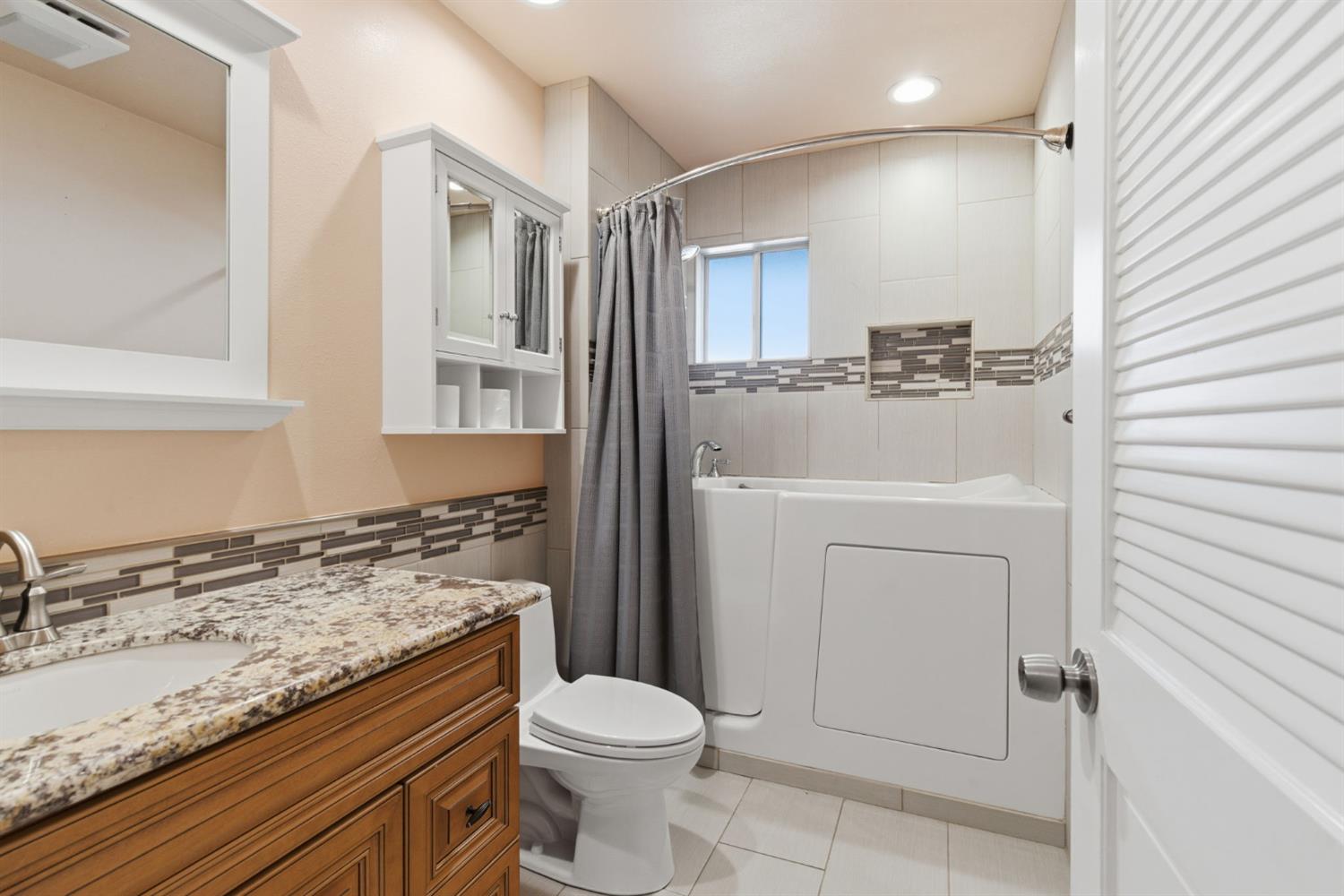 7348 Lighthouse Drive Stockton, CA 95219 - Photo 9 of 56 a bathroom with a granite countertop sink toilet and shower