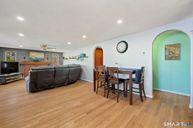 a view of a dining room with furniture and wooden floor