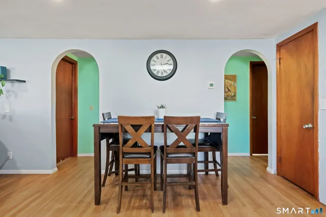 a view of a dining room with furniture window and wooden floor