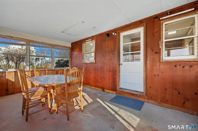 a dining room with furniture and window
