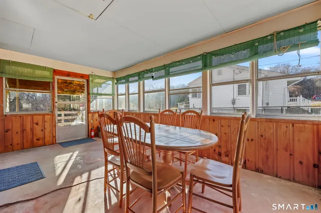 a view of a dining room with furniture large windows and wooden floor