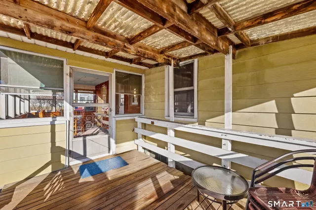 a backyard of a house with table and chairs
