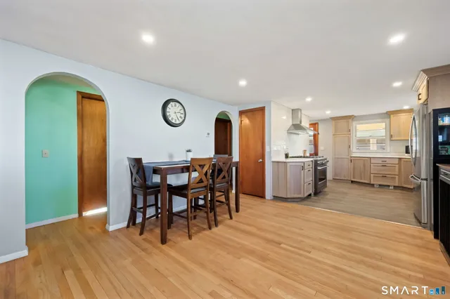 a view of a dining room with furniture and wooden floor