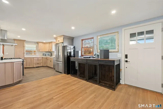 a kitchen with stainless steel appliances a stove top oven and a refrigerator