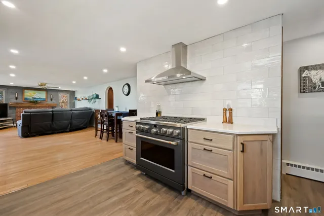 a kitchen with stainless steel appliances a stove a sink and a refrigerator