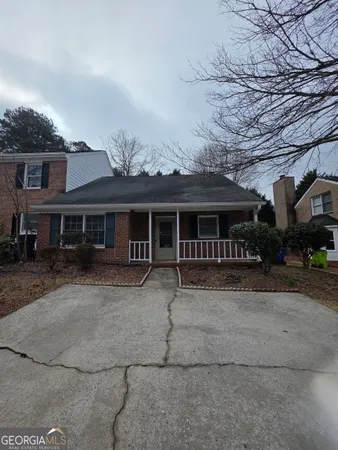 a front view of a house with a yard and seating space
