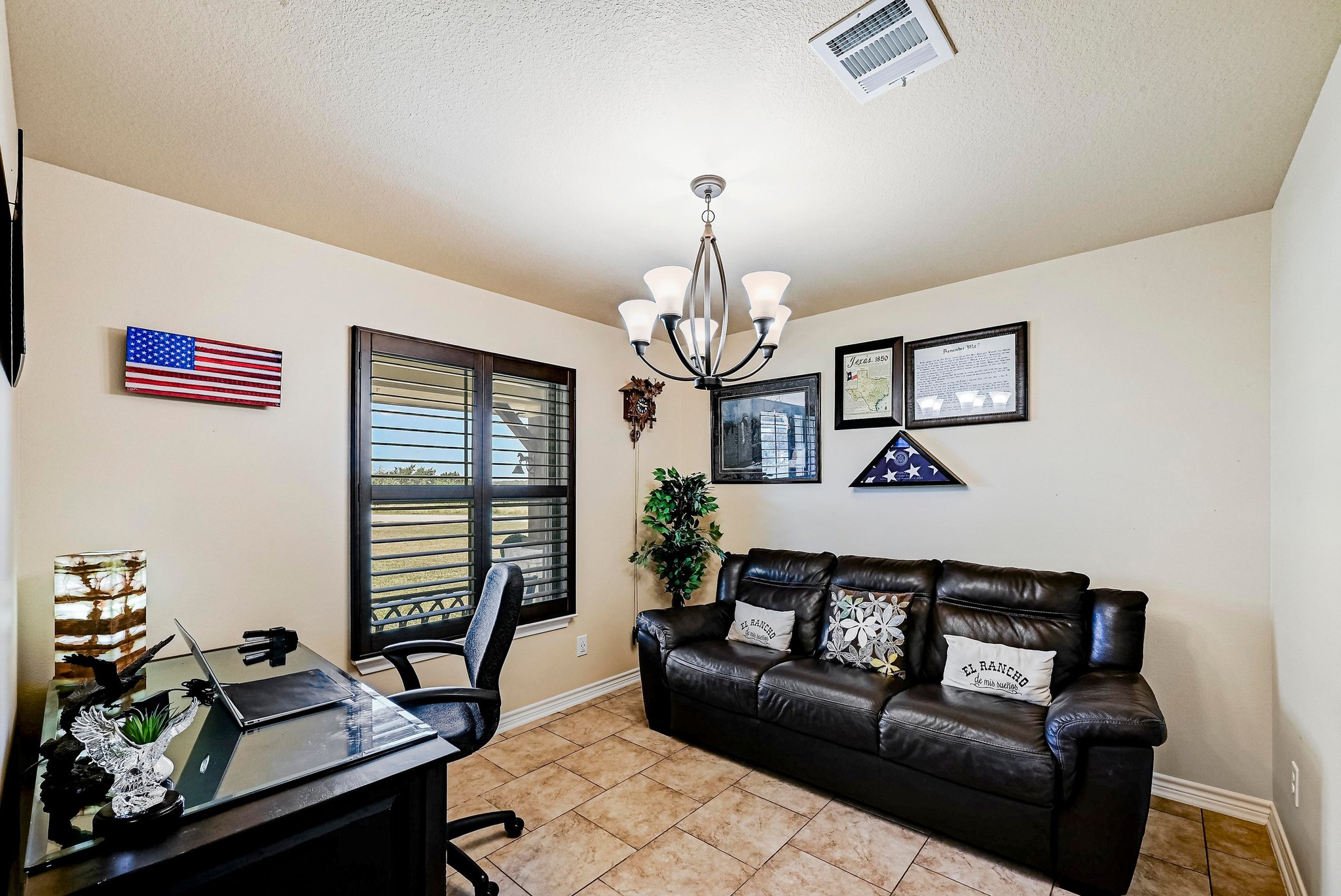 560 Saddle Ridge Drive Bertram, TX 78605 - Photo 5 of 27 a living room with furniture a chandelier and a window