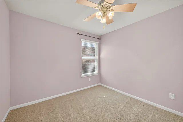 a bathroom with a granite countertop sink a toilet and a mirror