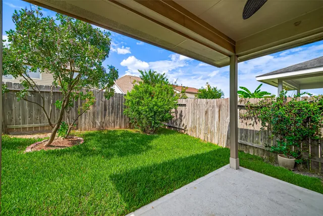 a view of a house with a yard and sitting area